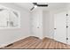 This bedroom offers natural light, a ceiling fan, wood floors, and neutral paint at 401 N Swope St, Greenfield, IN 46140