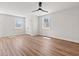 This bright bedroom has hardwood floors, fresh paint, a ceiling fan, and two windows at 401 N Swope St, Greenfield, IN 46140