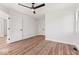 This bright bedroom features hardwood floors, fresh paint, a ceiling fan, and ensuite bathroom at 401 N Swope St, Greenfield, IN 46140