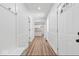 Inviting entryway with laminate flooring, wainscoting, coat hooks, and an open view into the updated kitchen at 401 N Swope St, Greenfield, IN 46140