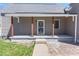 Charming home featuring a covered front porch with wooden pillars and decorative security door, perfect for curb appeal at 401 N Swope St, Greenfield, IN 46140