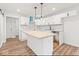 Modern kitchen features white cabinets, an island with butcher block top, and updated black hardware at 401 N Swope St, Greenfield, IN 46140