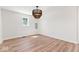 A bright living room featuring hardwood floors, fresh paint, and a modern chandelier at 401 N Swope St, Greenfield, IN 46140