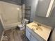 A full bathroom with a combination tub and shower, toilet and a single sink vanity at 406 W Broadway St, Alexandria, IN 46001