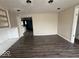Empty living room with dark laminate flooring and neutral walls showcasing open space and natural light at 406 W Broadway St, Alexandria, IN 46001
