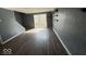 An open living room features wood flooring, textured walls, and sliding glass doors to the outside at 406 W Broadway St, Alexandria, IN 46001