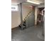 Basement stairs with a railing and access to a utility area, painted in neutral colors at 415 E 32Nd St, Indianapolis, IN 46205