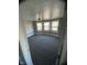 Empty bedroom offering three windows for natural light and installed carpeting at 415 E 32Nd St, Indianapolis, IN 46205