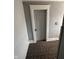 Neutral-toned hallway with carpet, highlighting a numbered door for added character at 415 E 32Nd St, Indianapolis, IN 46205