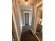 Hallway with carpet leading to a numbered door and a glimpse of the kitchen at 415 E 32Nd St, Indianapolis, IN 46205