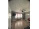 Bright living room with laminated floors, a ceiling fan, and a cozy window nook at 415 E 32Nd St, Indianapolis, IN 46205