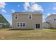 View of the home's back exterior featuring a sliding glass door to the backyard and neutral siding at 4152 Dutton Dr, Bargersville, IN 46106