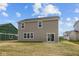 View of the home's back exterior featuring a sliding glass door to the backyard and neutral siding at 4152 Dutton Dr, Bargersville, IN 46106