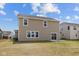 Back exterior view of the home, highlighting the neutral siding and lawn at 4152 Dutton Dr, Bargersville, IN 46106