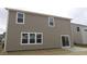 A view of the back exterior featuring a sliding glass door and a concrete patio at 4152 Dutton Dr, Bargersville, IN 46106