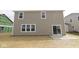 A view of the back exterior featuring a sliding glass door and a concrete patio at 4152 Dutton Dr, Bargersville, IN 46106