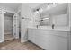 Bright bathroom featuring a double sink vanity, large mirror, and a walk-in closet at 4152 Dutton Dr, Bargersville, IN 46106