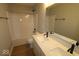 Bright bathroom featuring a double vanity, tub, and black hardware at 4152 Dutton Dr, Bargersville, IN 46106