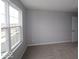 Bright bedroom featuring neutral carpet and gray walls, with a large window at 4152 Dutton Dr, Bargersville, IN 46106