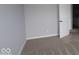 Cozy bedroom with gray carpet and walls, showcasing a white door at 4152 Dutton Dr, Bargersville, IN 46106