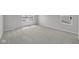 A well-lit bedroom featuring neutral walls, plush gray carpet, and large windows at 4152 Dutton Dr, Bargersville, IN 46106
