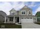 Two story home with stone accents, a two-car garage, and a covered entryway at 4152 Dutton Dr, Bargersville, IN 46106