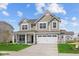 Charming two-story home with a well-manicured lawn, large windows and a two car garage on a beautiful sunny day at 4152 Dutton Dr, Bargersville, IN 46106