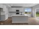 Bright kitchen features stainless appliances, recessed lighting, white cabinets and a center island at 4152 Dutton Dr, Bargersville, IN 46106