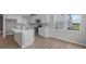 Bright kitchen features stainless appliances, recessed lighting, a center island, white cabinets and wood flooring at 4152 Dutton Dr, Bargersville, IN 46106