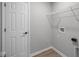 Functional laundry room with shelving for storage and access to washer and dryer hookups at 4152 Dutton Dr, Bargersville, IN 46106