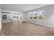 Open-concept living room with wood flooring and natural light flowing from the sliding glass door and windows at 4152 Dutton Dr, Bargersville, IN 46106
