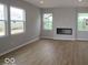 Modern living room featuring a sleek fireplace and hardwood floors at 4152 Dutton Dr, Bargersville, IN 46106