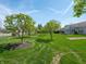 Lush backyard with mature trees and landscaping, offering a serene outdoor space at 4631 Belair Cir, Plainfield, IN 46168