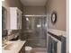Bathroom featuring double sinks with a glass enclosed shower, offering a clean and modern aesthetic at 4631 Belair Cir, Plainfield, IN 46168