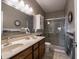 Lovely bathroom featuring double sinks, a large mirror, and a glass door shower at 4631 Belair Cir, Plainfield, IN 46168