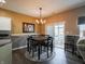 The dining room features a chandelier, wainscoting, and access to the outdoor patio at 4631 Belair Cir, Plainfield, IN 46168