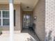 Inviting covered entryway with neutral brick, ideal for greeting guests and enjoying a quiet moment at 4631 Belair Cir, Plainfield, IN 46168