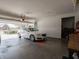 Spacious two-car garage with epoxy flooring featuring a white car at 4631 Belair Cir, Plainfield, IN 46168
