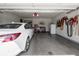 Spacious garage with overhead door, white car, storage, and tools, offering ample space for vehicles and projects at 4631 Belair Cir, Plainfield, IN 46168