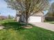 Spacious two-car garage adjacent to a well-kept yard and landscaped area at 4631 Belair Cir, Plainfield, IN 46168