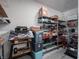 Garage storage area with shelves, bins, and yard equipment at 4631 Belair Cir, Plainfield, IN 46168