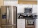 Modern kitchen with stainless steel refrigerator, microwave, and oven with ample counter space at 4631 Belair Cir, Plainfield, IN 46168