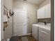 Laundry room with washer, dryer, cabinets, and utility door at 4631 Belair Cir, Plainfield, IN 46168