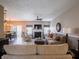 Cozy living room with a fireplace, comfortable seating, and an open view to the dining area at 4631 Belair Cir, Plainfield, IN 46168