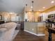 Open-concept living room and kitchen boasts modern fixtures, stainless appliances, and hardwood flooring at 4631 Belair Cir, Plainfield, IN 46168