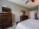 Neutral main bedroom with dark furniture and access to the ensuite bathroom and walk-in closet at 4631 Belair Cir, Plainfield, IN 46168