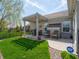 Charming brick patio with pergola, barbecue grill, table, chairs and lush green lawn for outdoor gatherings at 4631 Belair Cir, Plainfield, IN 46168