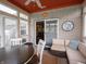 Inviting sunroom with brick walls, tile floors, and comfortable seating, perfect for relaxation and entertaining at 4631 Belair Cir, Plainfield, IN 46168