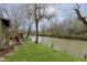 Riverside backyard featuring a stone patio and lush green lawn at 5110 Riverview Dr, Indianapolis, IN 46208
