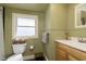 Charming bathroom with beadboard paneling, a classic vanity, and a well-lit window at 5110 Riverview Dr, Indianapolis, IN 46208